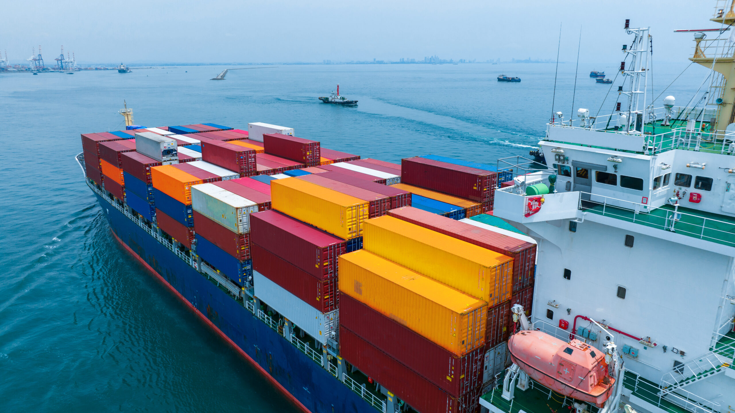 Aerial side view of cargo ship carrying container and running for export  goods  from  cargo yard port to custom ocean concept technology transportation , customs clearance.