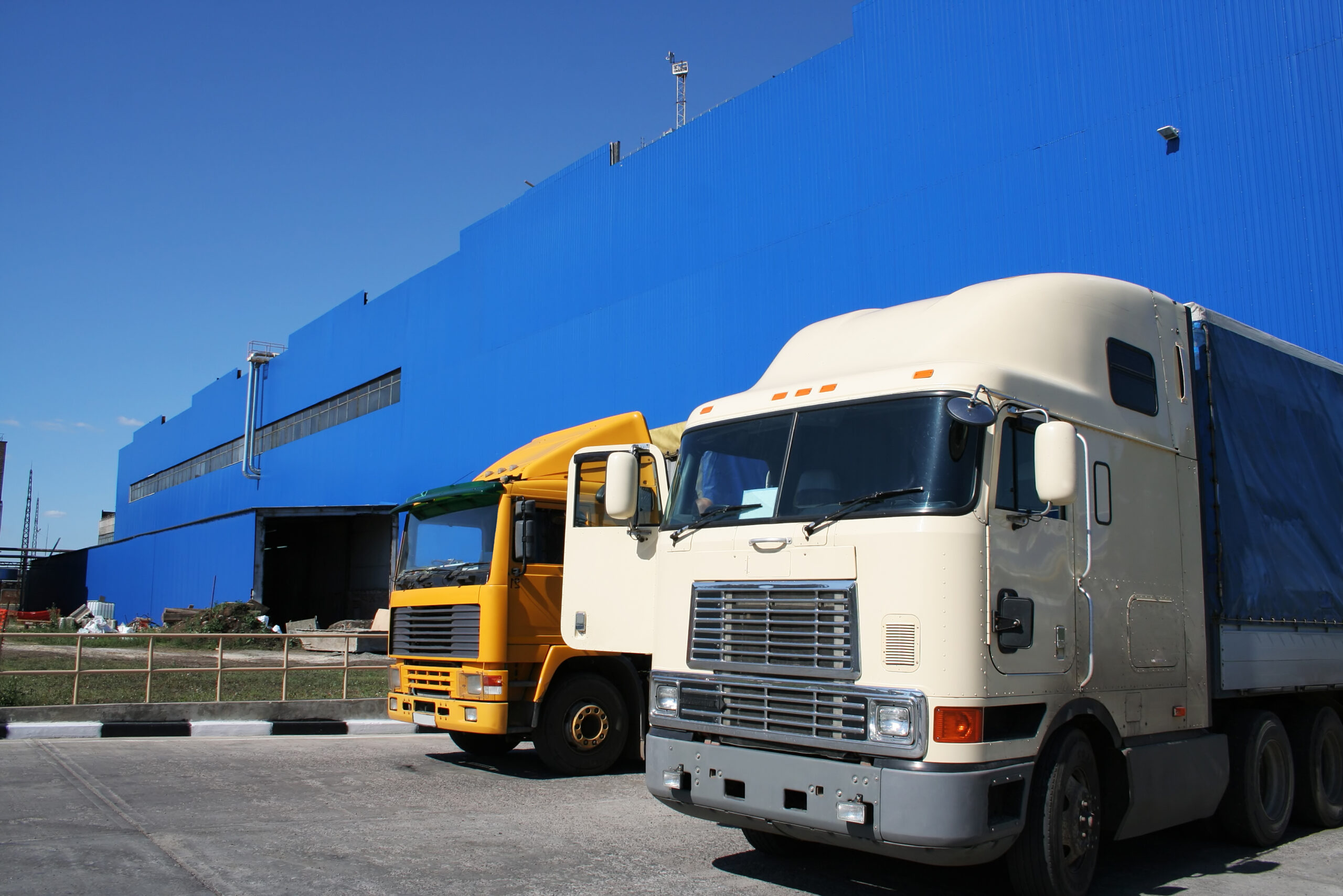 Two powerful lorries at a modern factory